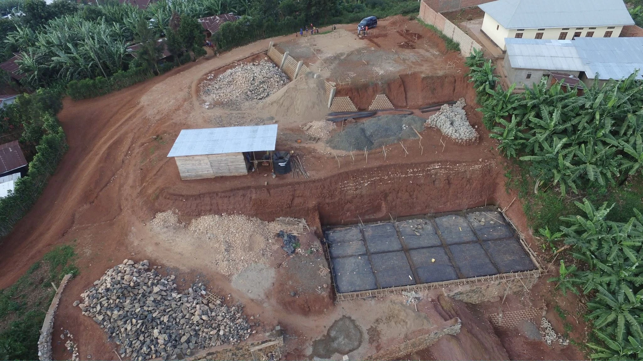 Original drone view of Connection Hotel site preparation, terraced earthworks and early structural works